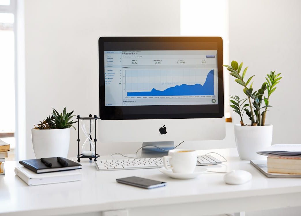 desktop workspace with analytics dashboard on screen