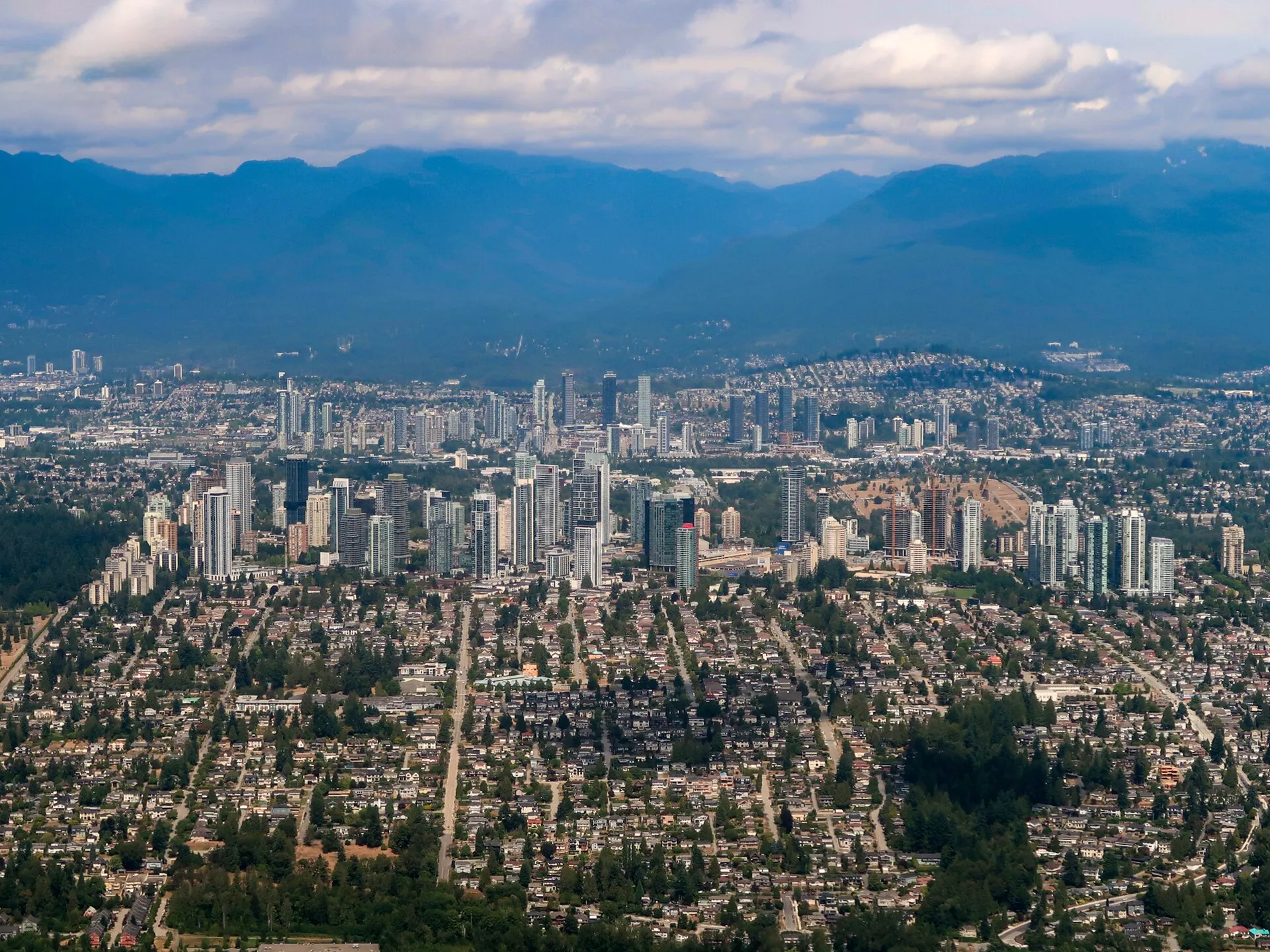 Aerial view of Metrotown's towers in Burnaby with the North Shore mountains behind